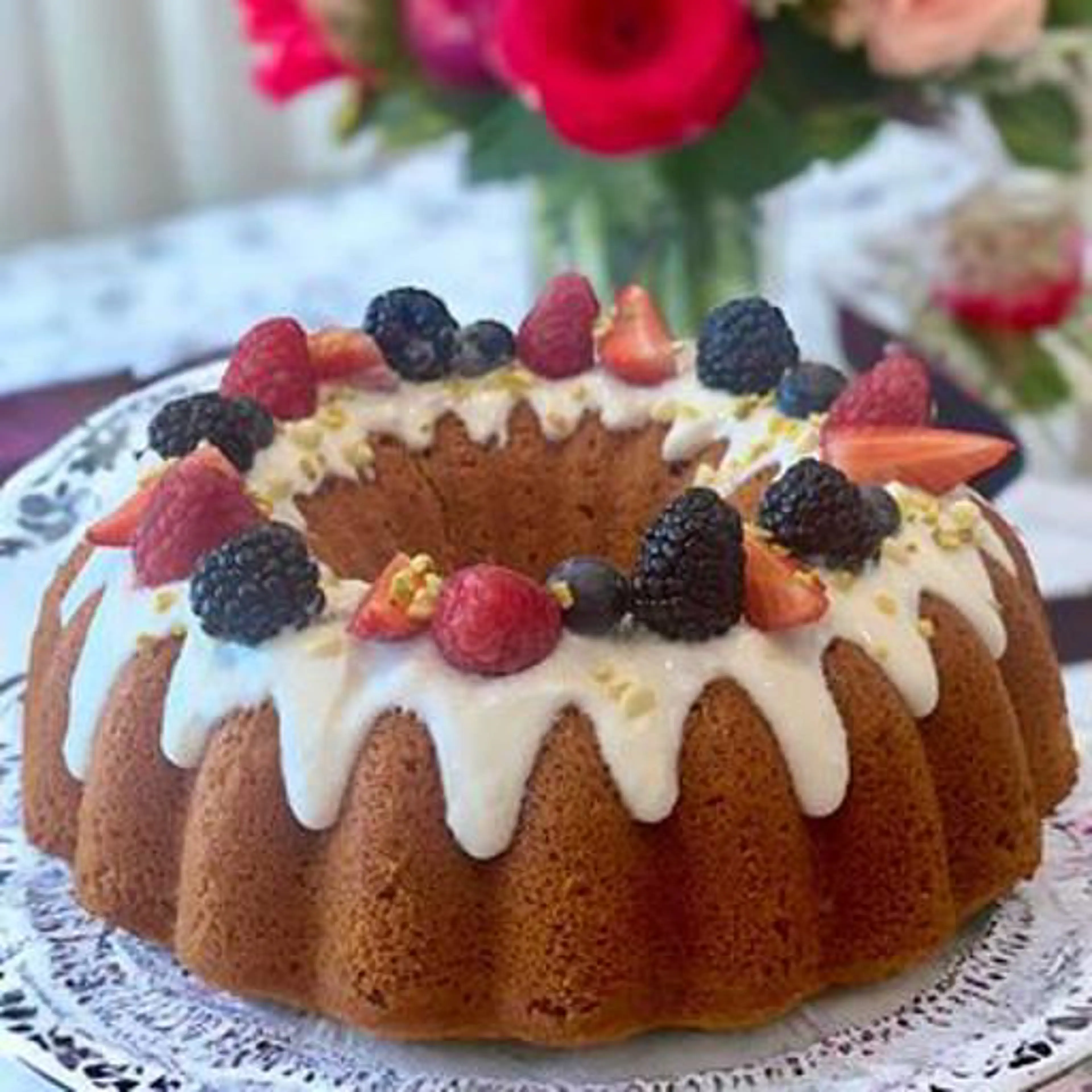 Strawberry cake with coconut frosting and red berries