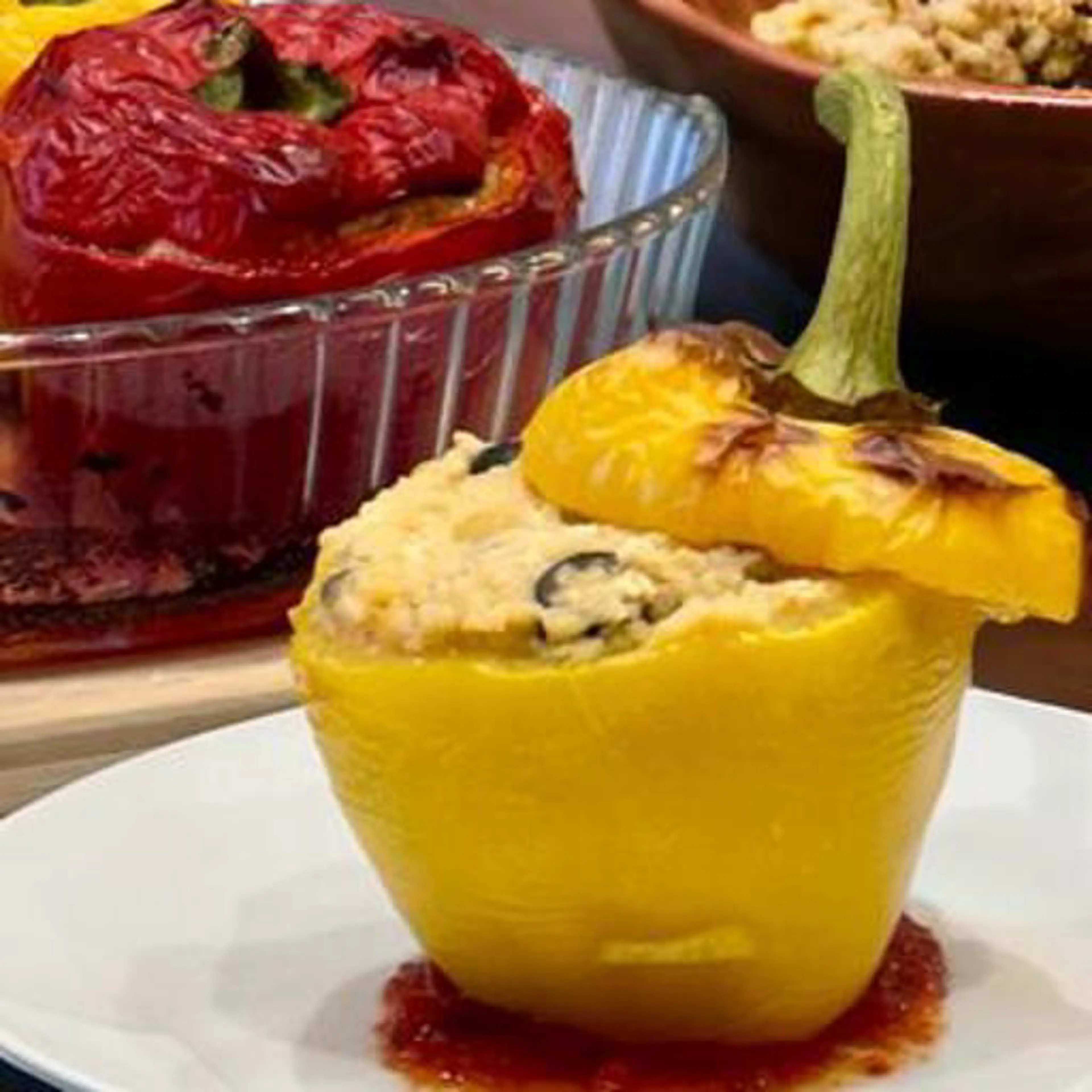 Stuffed peppers with couscous, vegetables, smoked tofu and tahini sauce