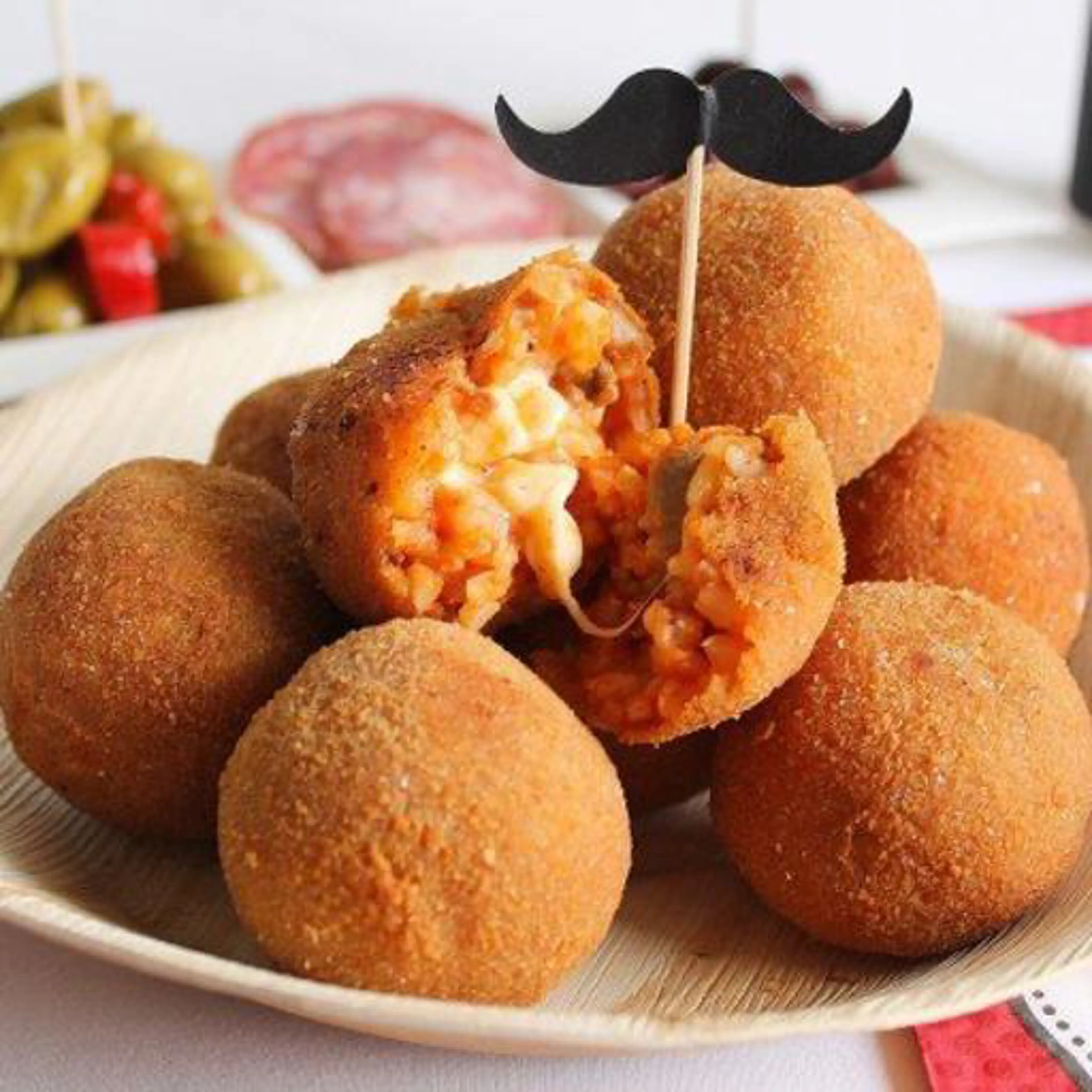Mini arancine with sausage ragù, mushrooms and stretchy mozzarella