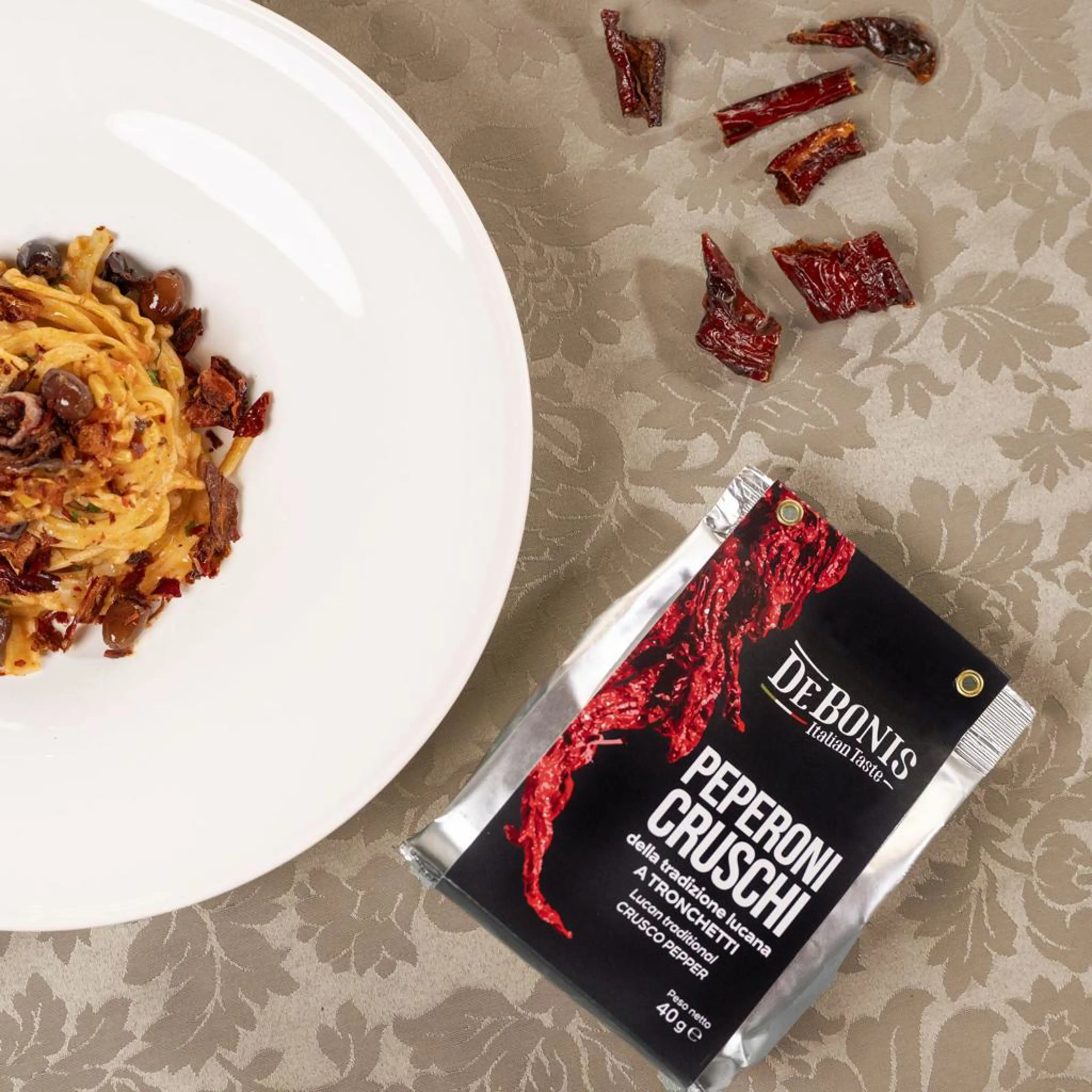 Red mafaldine with anchovies, garlic, parsley and taggiasca olives
