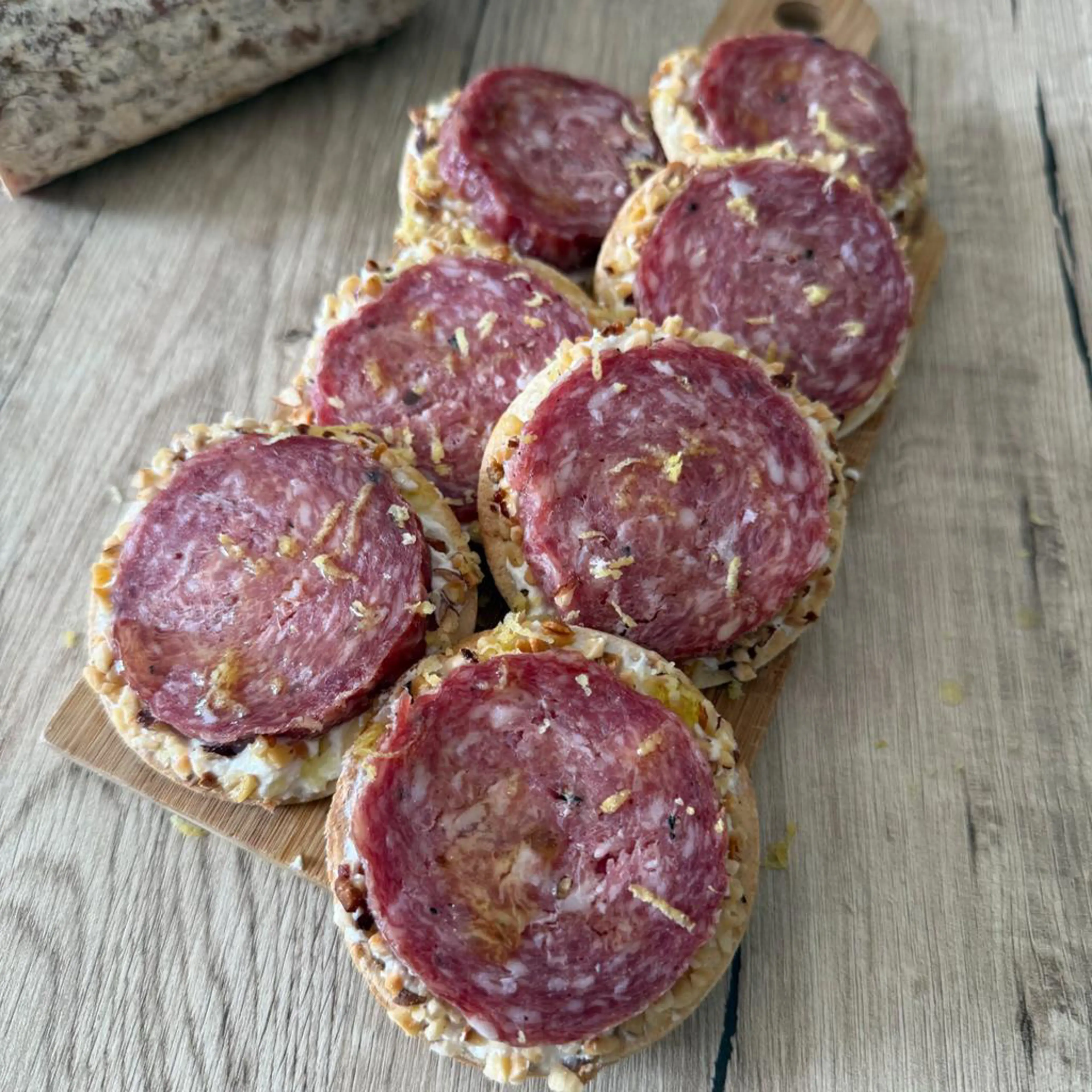 Crispy piadina tartines with truffle salami, ricotta and hazelnuts