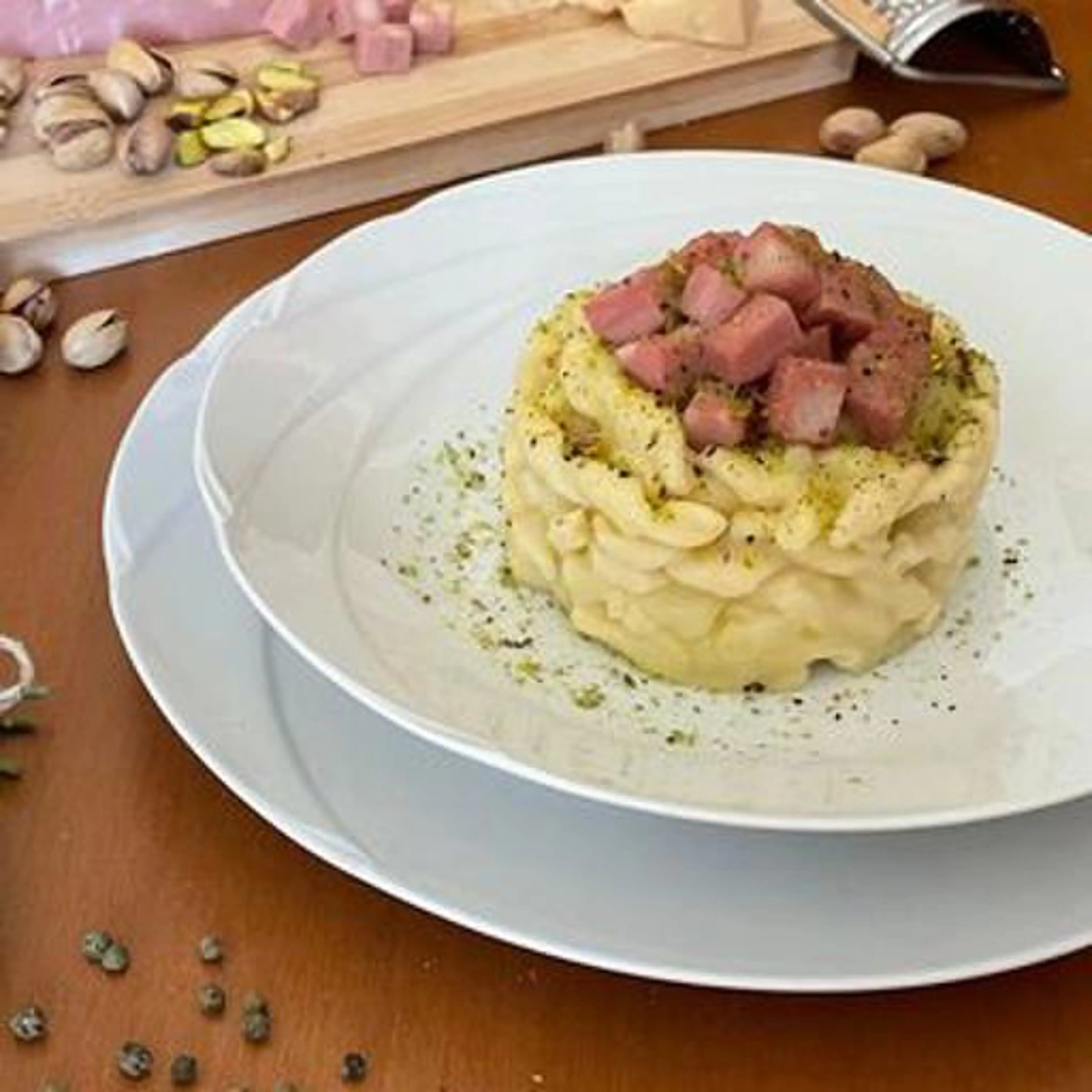 Trofie with potato cream, mortadella and chopped pistachios