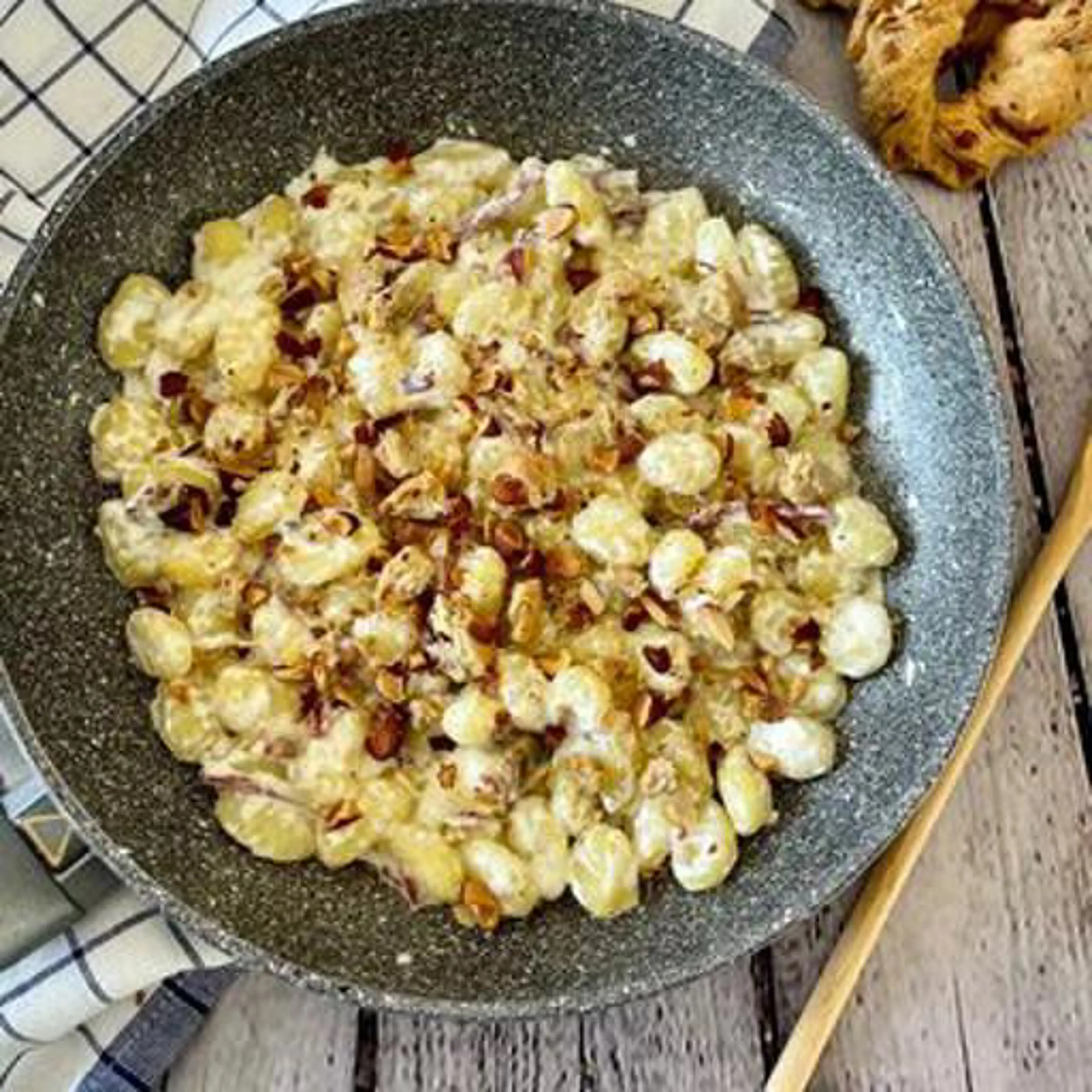 Gnocchi with stracciatella, speck and tarallo