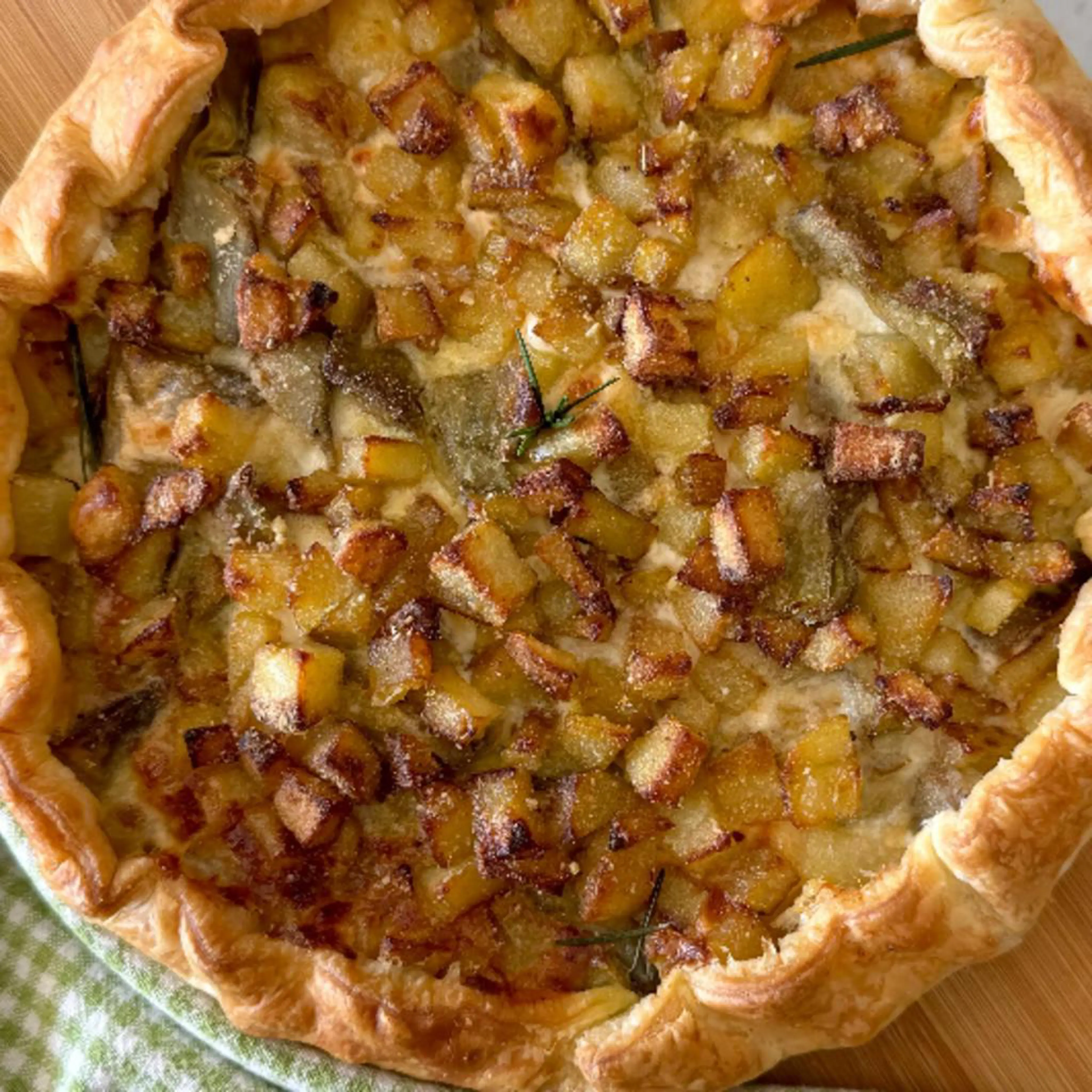 Savory pie with potatoes, artichokes, stracchino and coppa